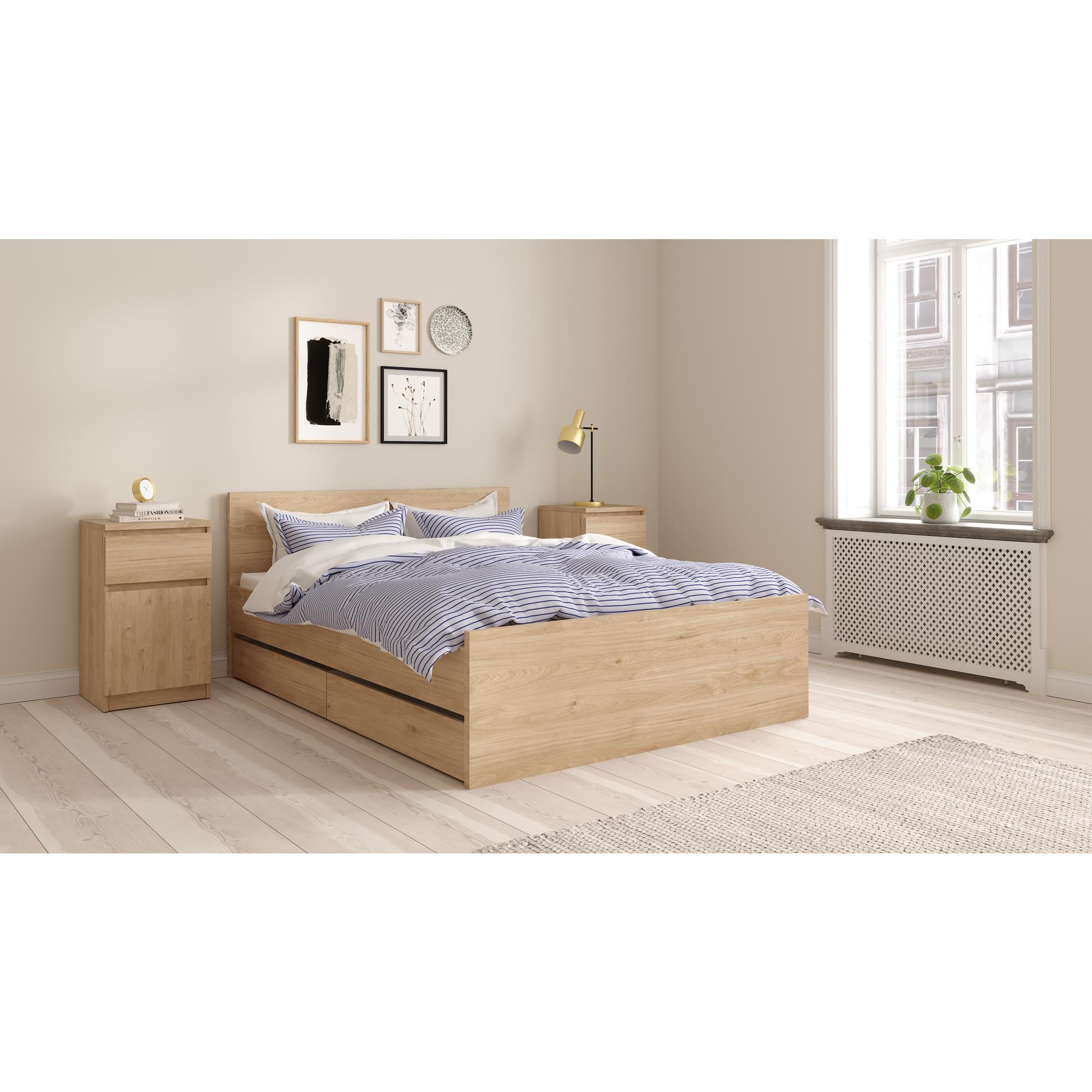 Un dormitorio con cama de madera, ropa de cama a rayas, mesitas de noche y arte de pared.