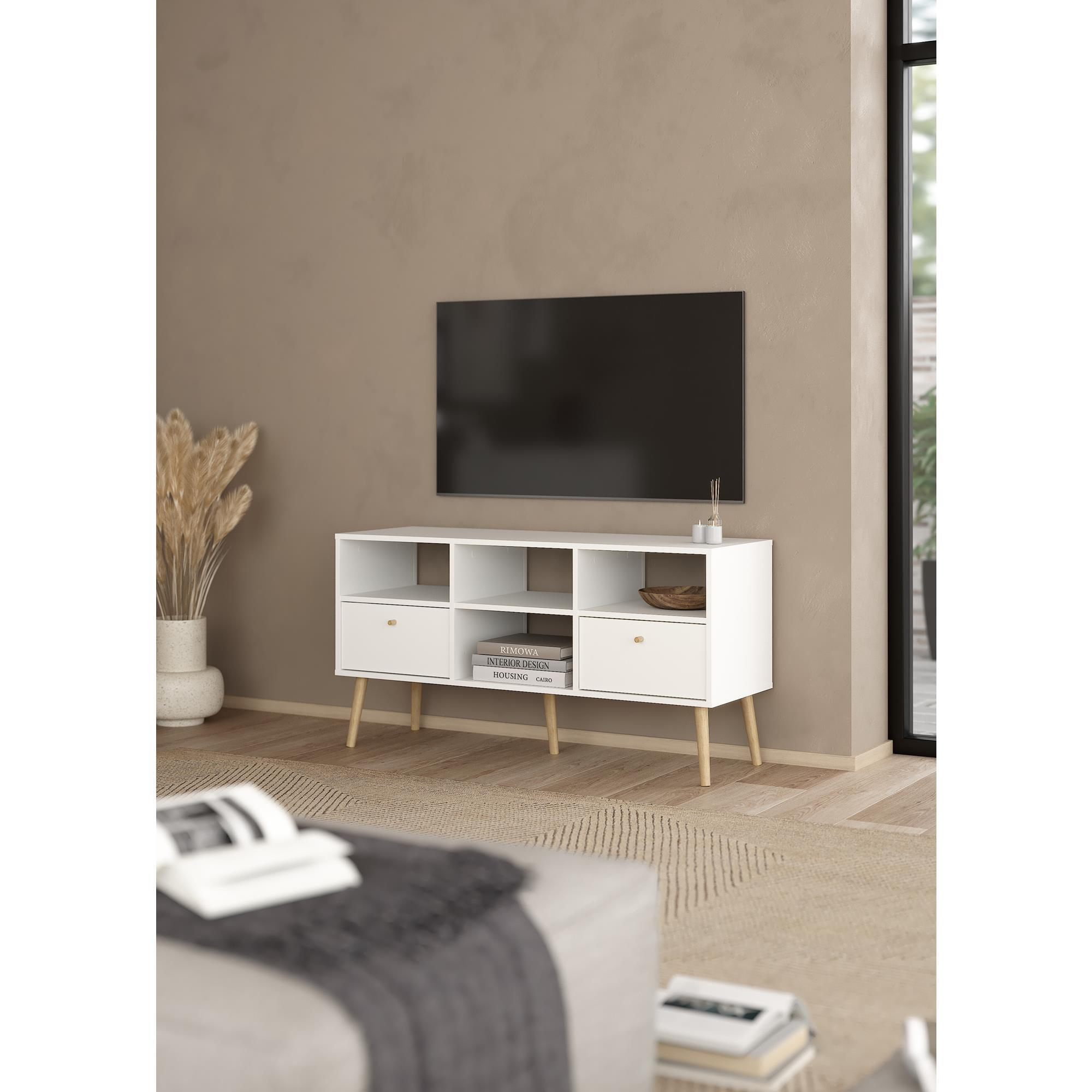 Un mueble de TV blanco con patas de madera, un televisor y objetos decorativos.