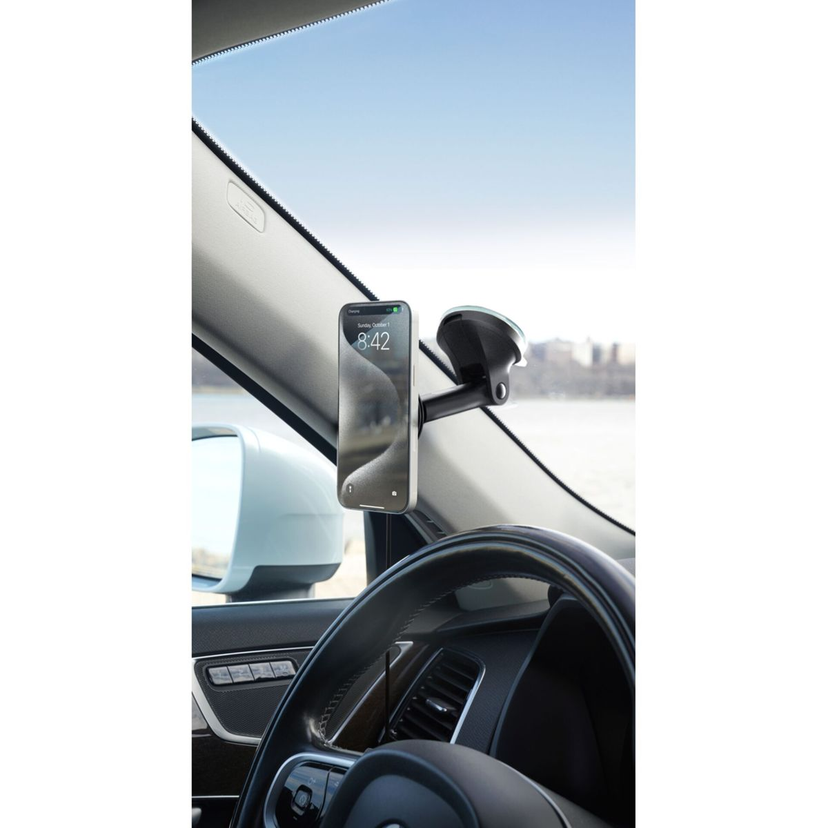 Ein Smartphone wird von einer Halterung an der Windschutzscheibe eines Autos gehalten.