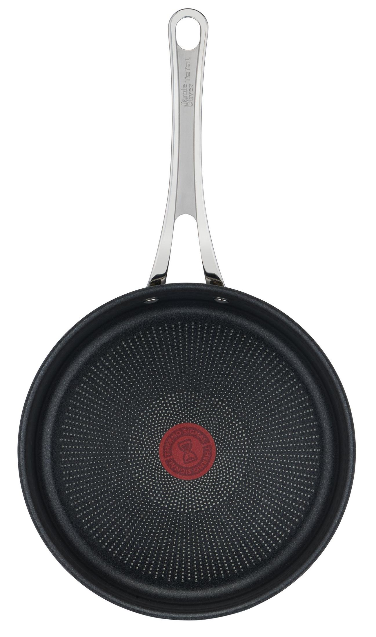 Eine schwarze Bratpfanne mit silbernem Griff und rotem Thermo-Signal-Logo.