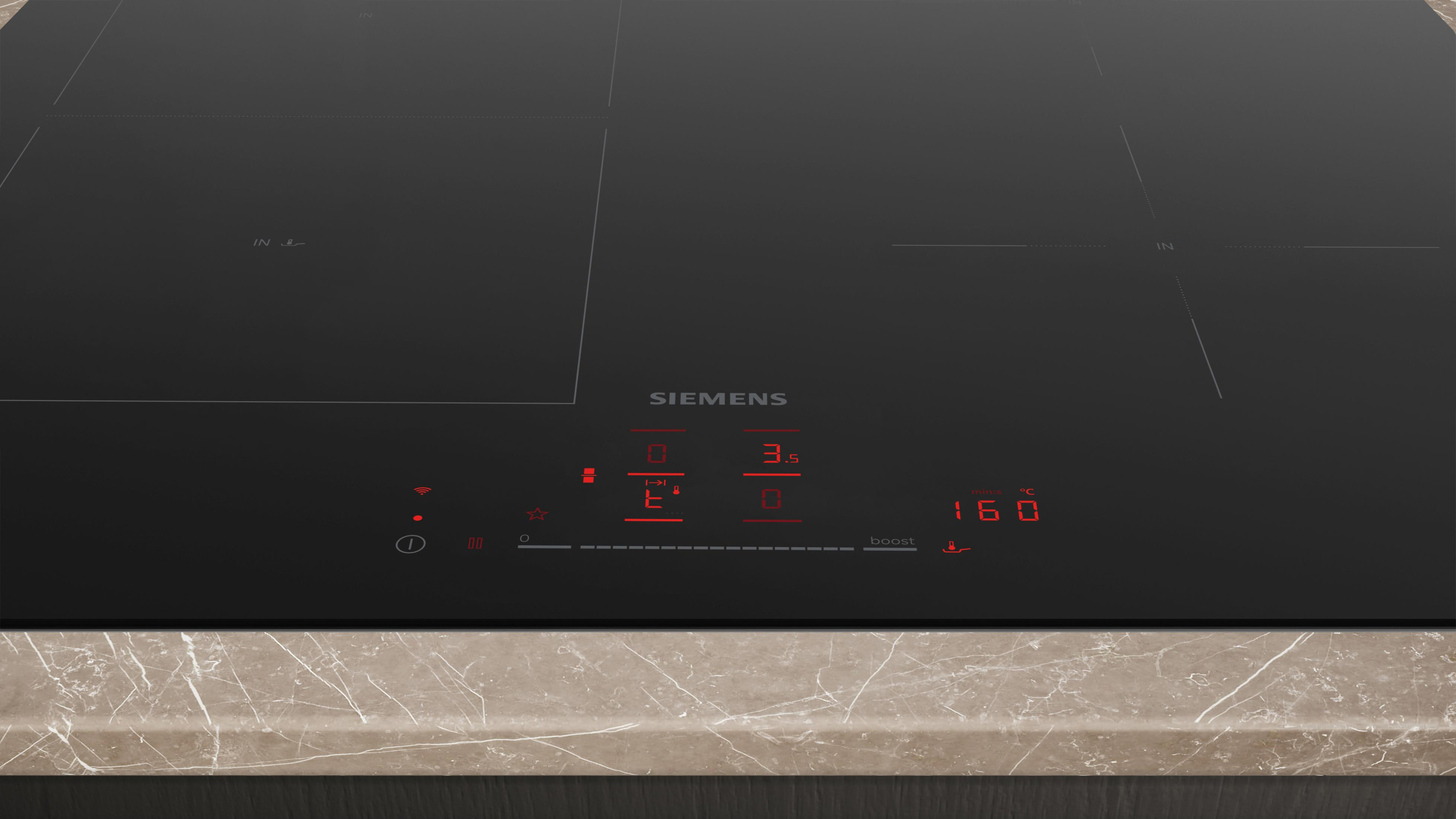 Een moderne zwarte inductiekookplaat met rode digitale displays.
