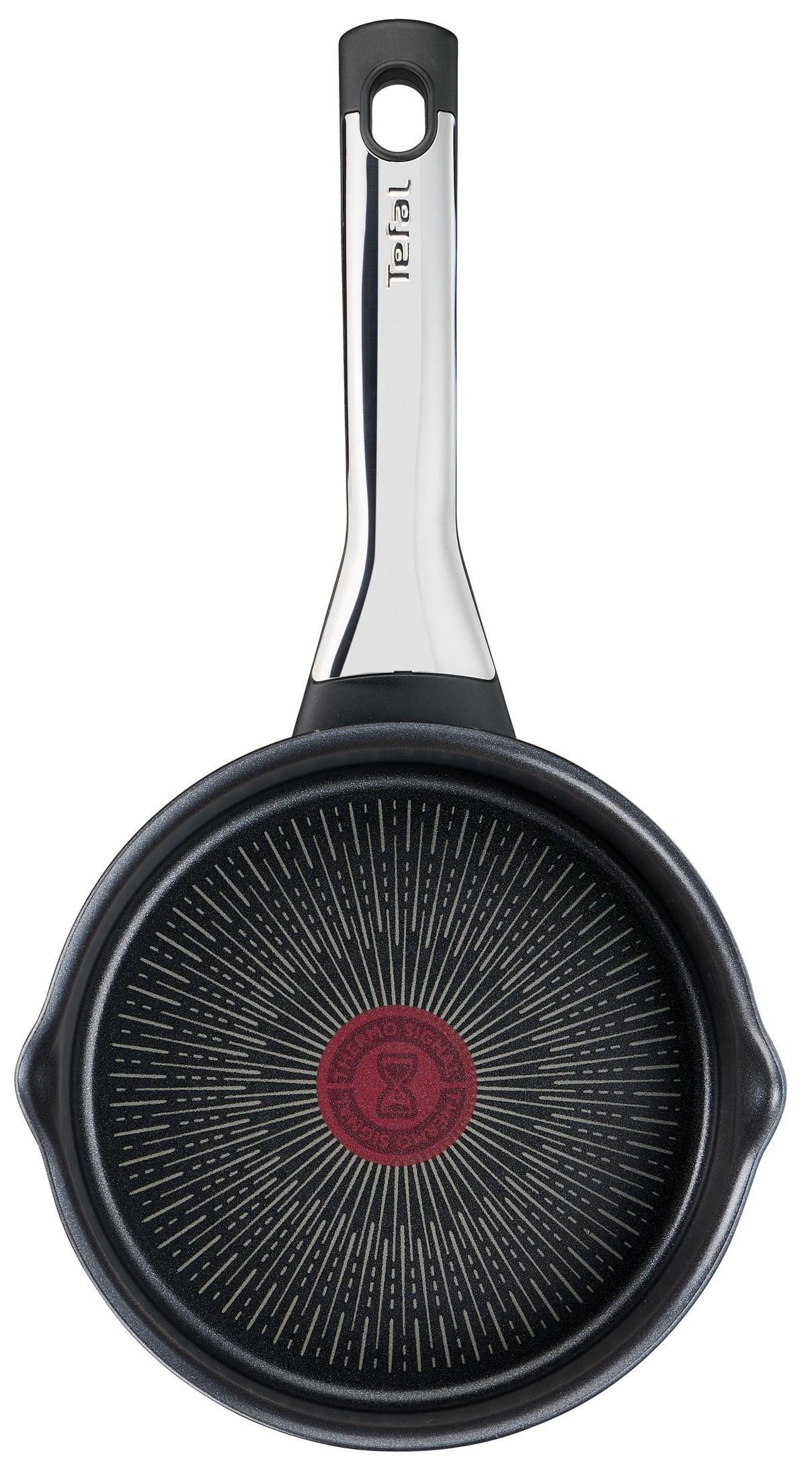 Une poêle Tefal noire avec un manche argenté et indicateur thermalsignal rouge.