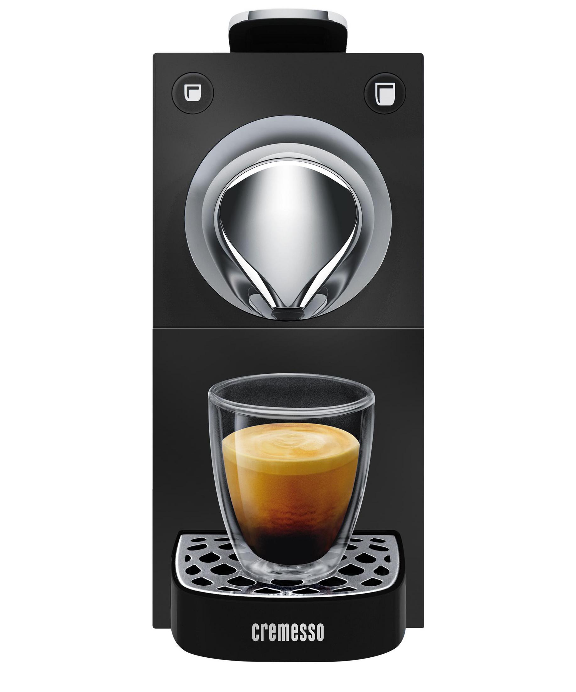 Schwarze Kaffeemaschine mit einem Glas Espresso und cremigem Schaum.