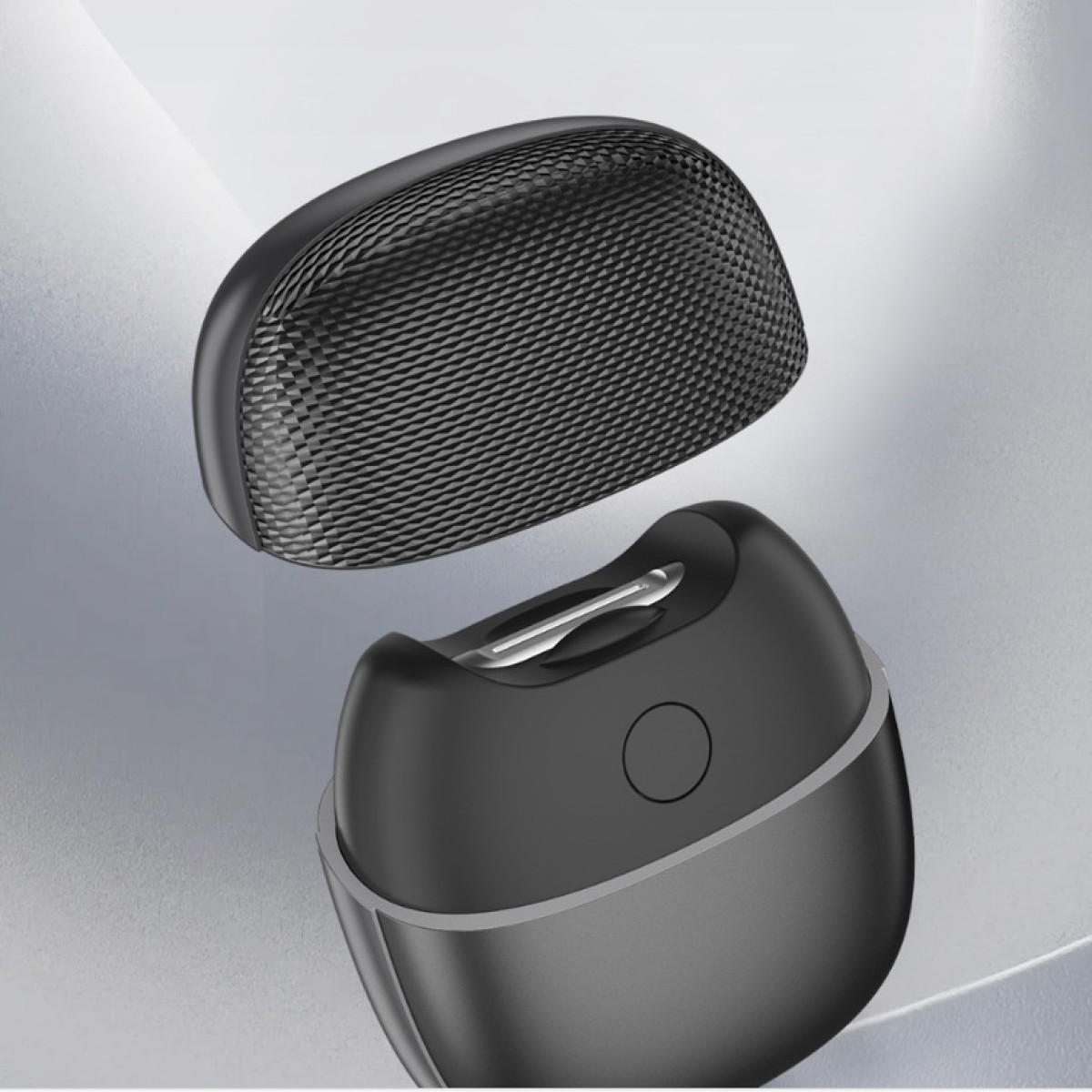 Czarno-owalne urządzenie z odłączoną, teksturowaną górną pokrywą.