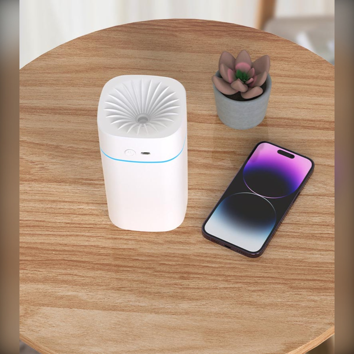 Biały nawilżacz, roślina doniczkowa i telefon na drewnianym stole.