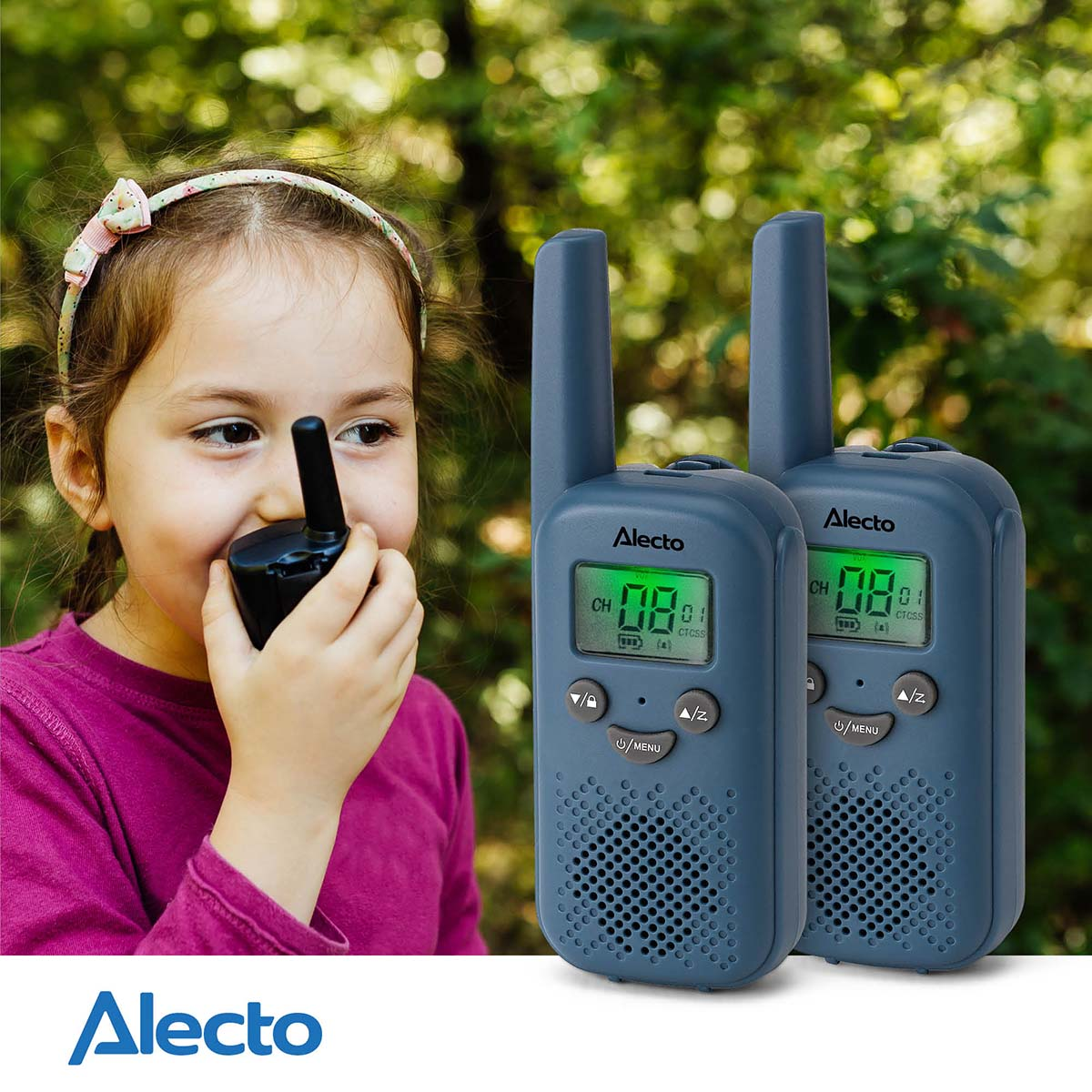 A girl holds a walkie-talkie, with two more beside her outdoors.
