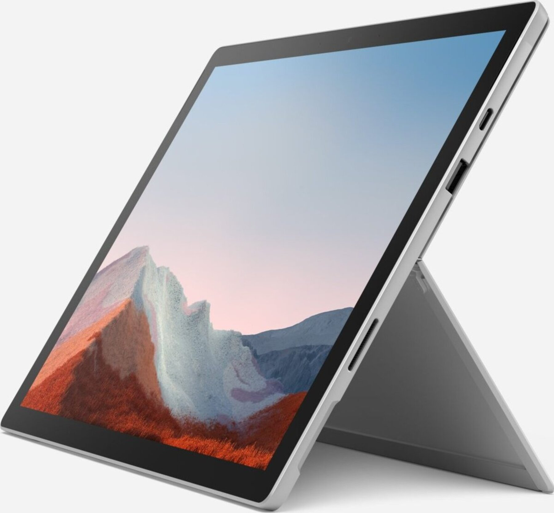 Silberner Laptop mit Ständer, der einen Berg mit rotem Gras und blauem Himmel zeigt.