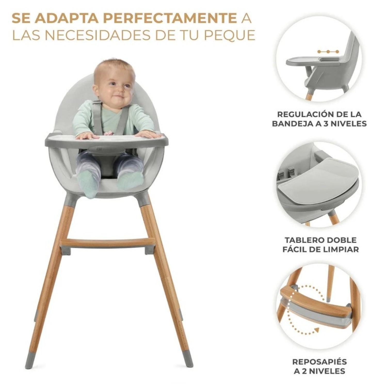 Ein Baby sitzt in einem grauen Hochstuhl mit Holzbeinen.