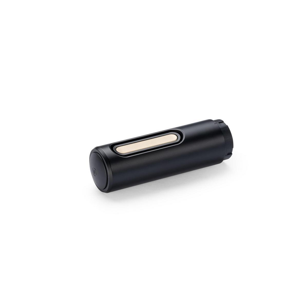 Un oggetto cilindrico nero con una striscia beige e dettaglio argentato.
