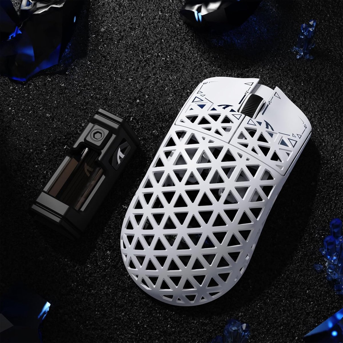 White honeycomb gaming mouse next to black object on dark background.