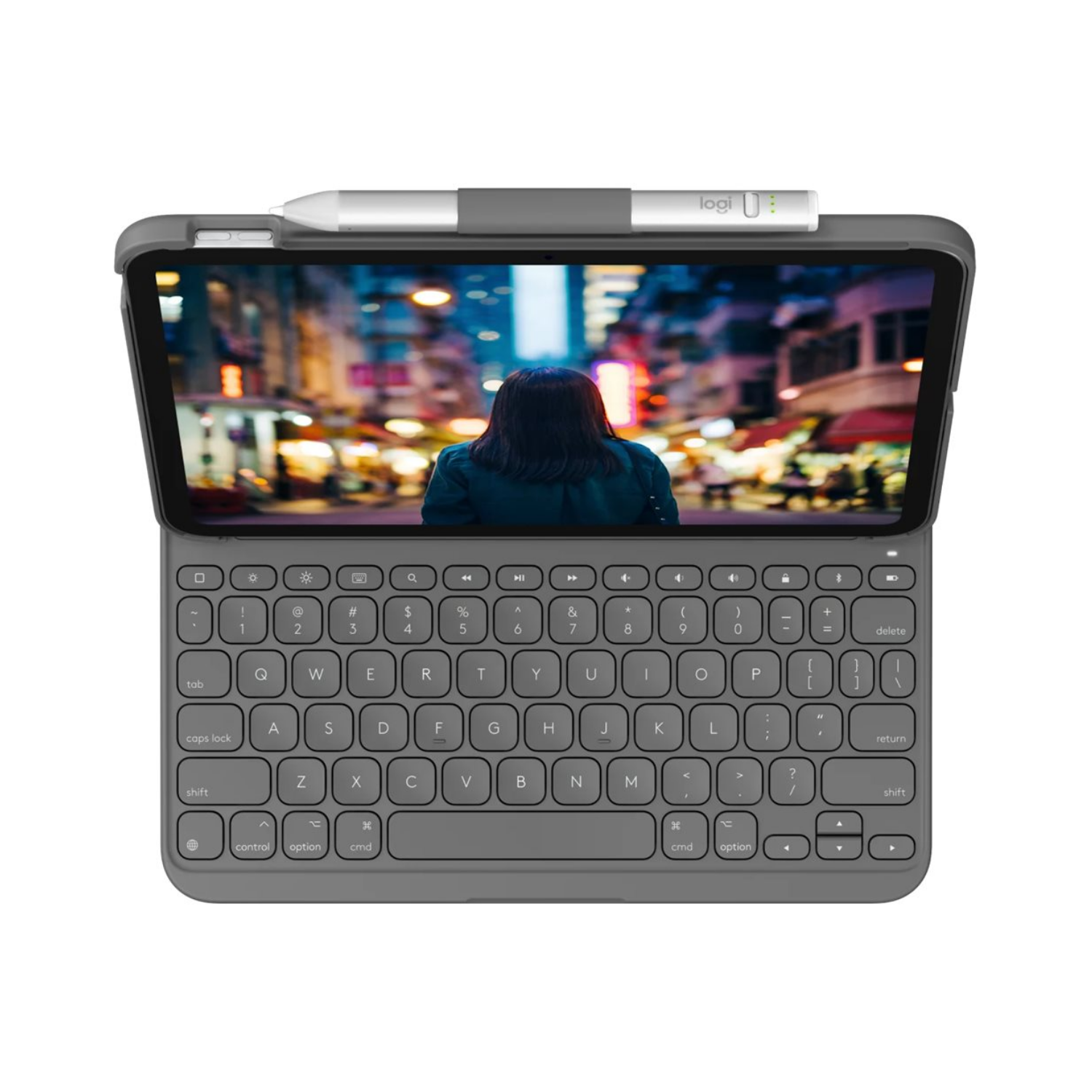 Szary tablet z klawiaturą i rysikiem, wyświetlający ruchliwą ulicę miasta.