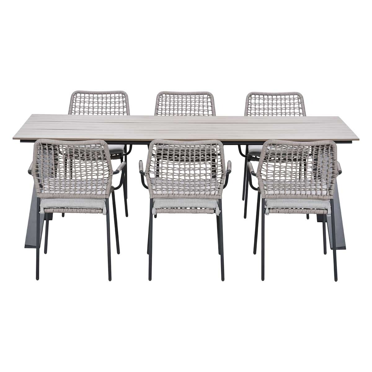 A rectangular table with six grey woven chairs with cushions.