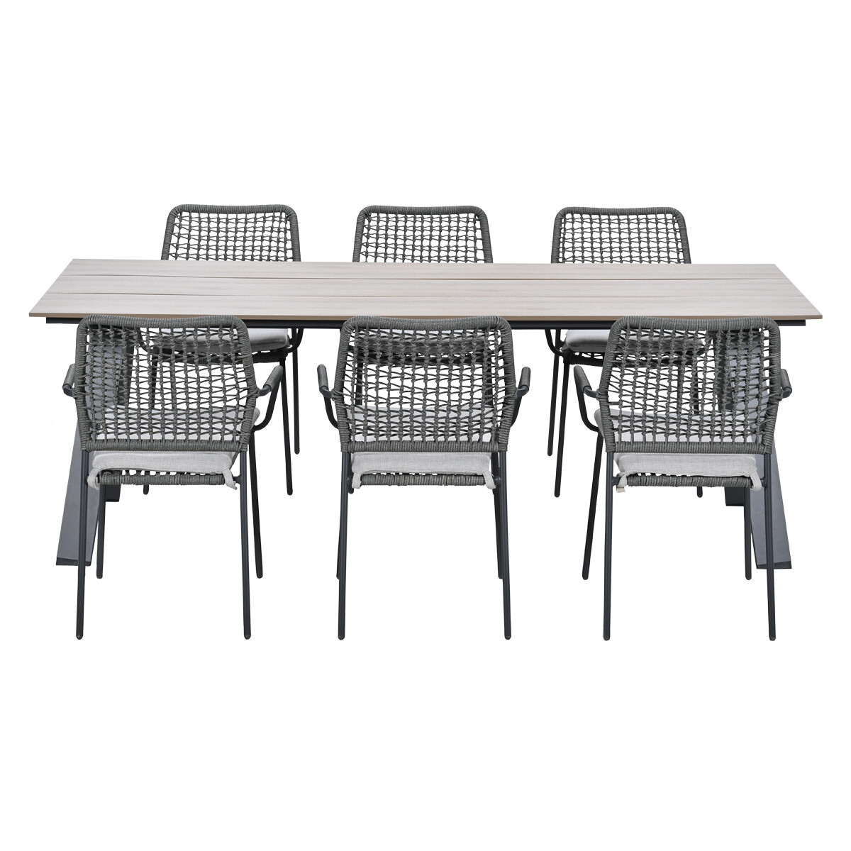 A grey dining table with six woven chairs with white cushions.