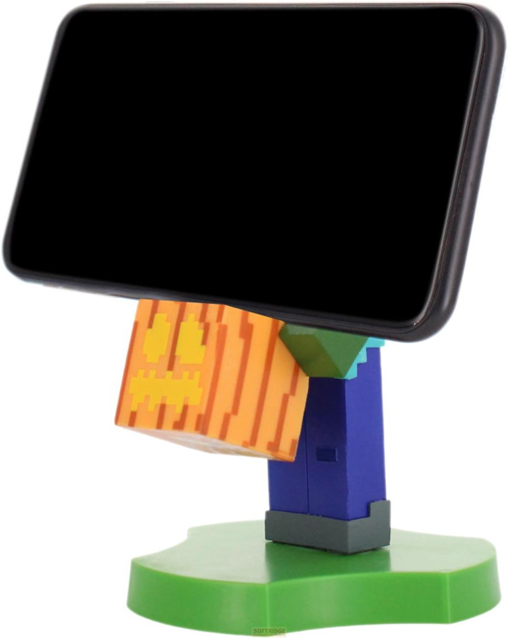 Ein Smartphone ruht auf einem Minecraft-Charakter-Ständer mit Kürbis. Grüne Basis.