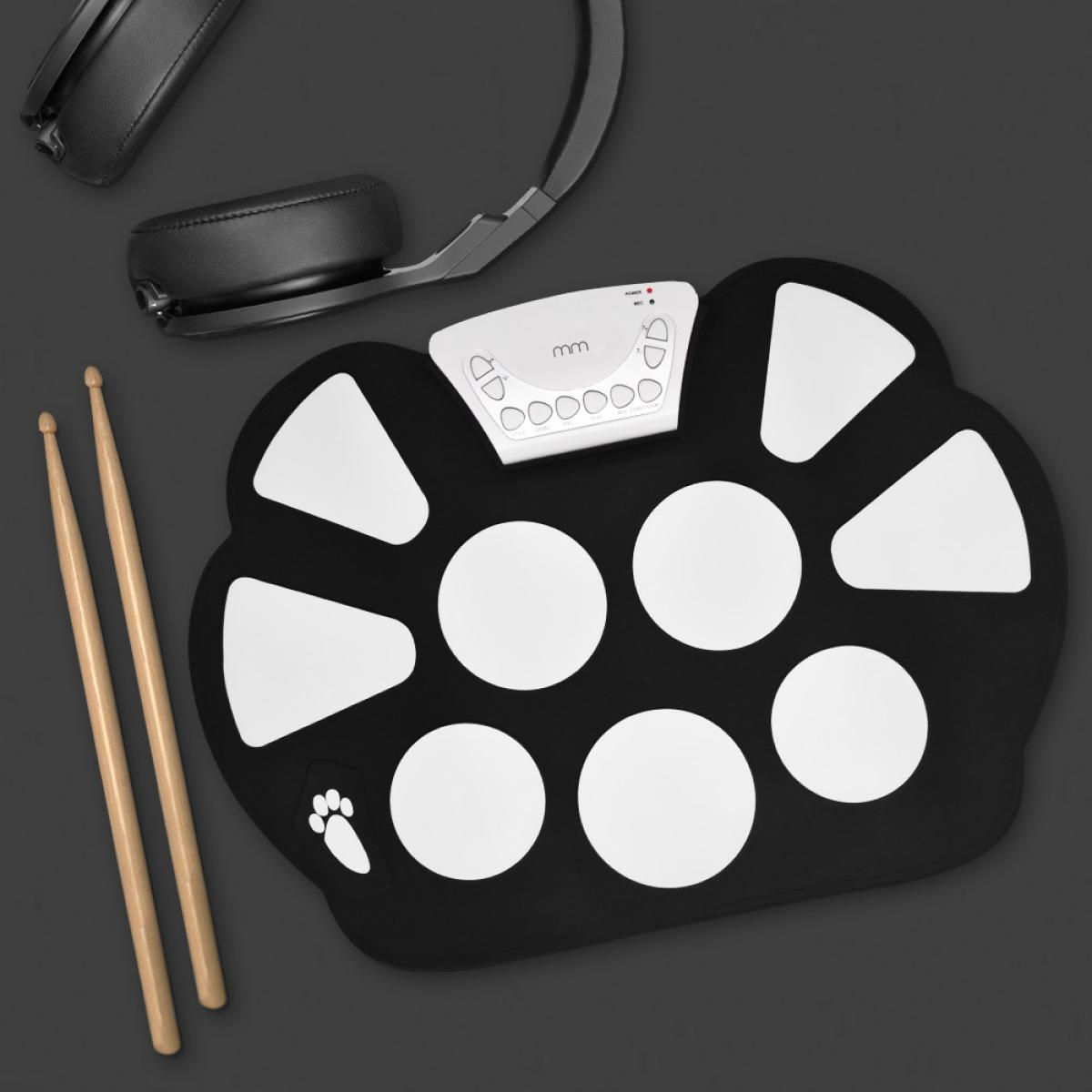 Black electronic drum pad with white pads, headphones, and drumsticks on a dark background.