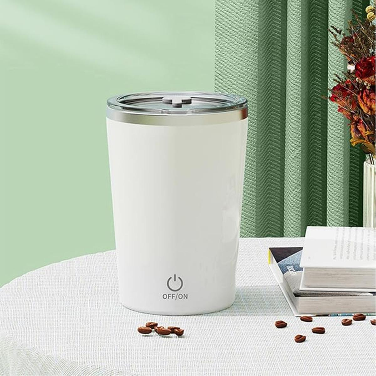 White tumbler with silver lid and power symbol on a table.