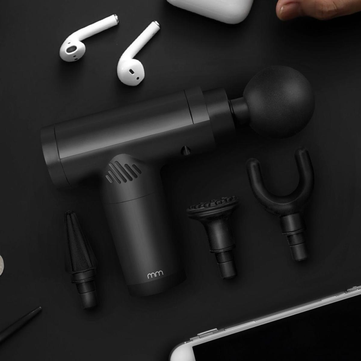 Black massage gun with attachments, earbuds, and smartphone on a dark background.
