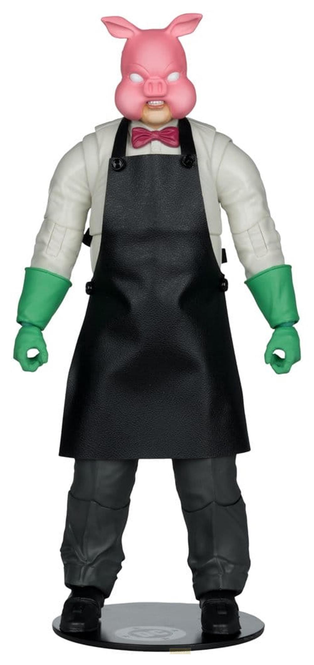 Eine Figur mit Schweinemaske, Schürze und grünen Handschuhen.
