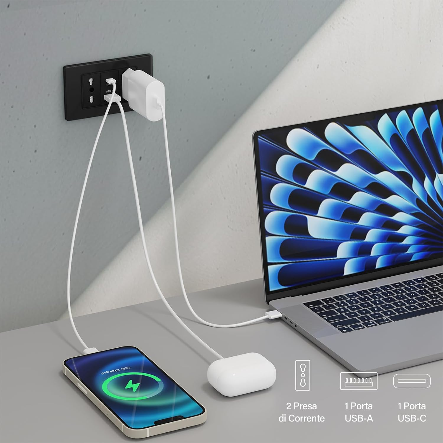 Uno smartphone, AirPods e un laptop si caricano tramite un adattatore di corrente.
