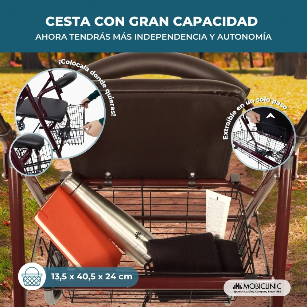 Un andador rojo con una cesta grande que contiene una botella y un libro.