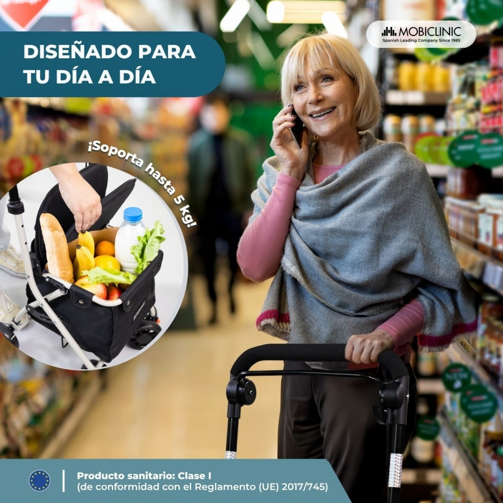 Una mujer con andador habla por teléfono en un supermercado, cesta llena.