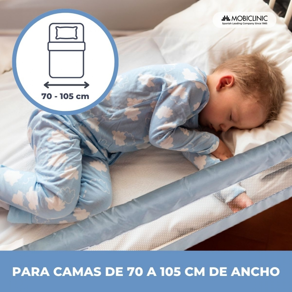Un niño duerme en una cama con barrera, apta para camas de 70-105 cm.