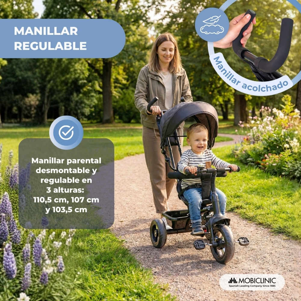 Una mujer empuja a un niño en triciclo en un parque. Manillar regulable.