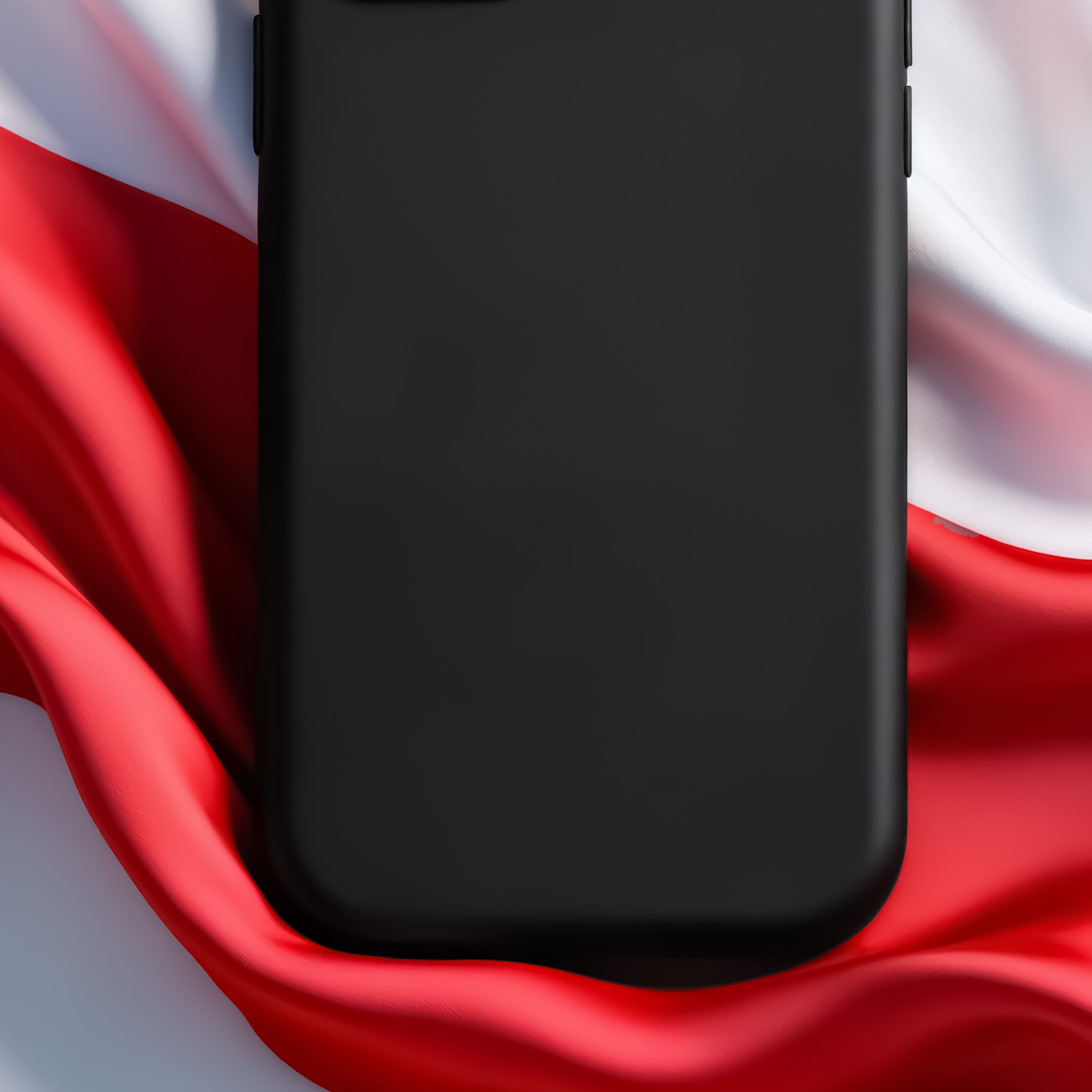 Czarny smartfon leży na czerwono-białej tkaninie.