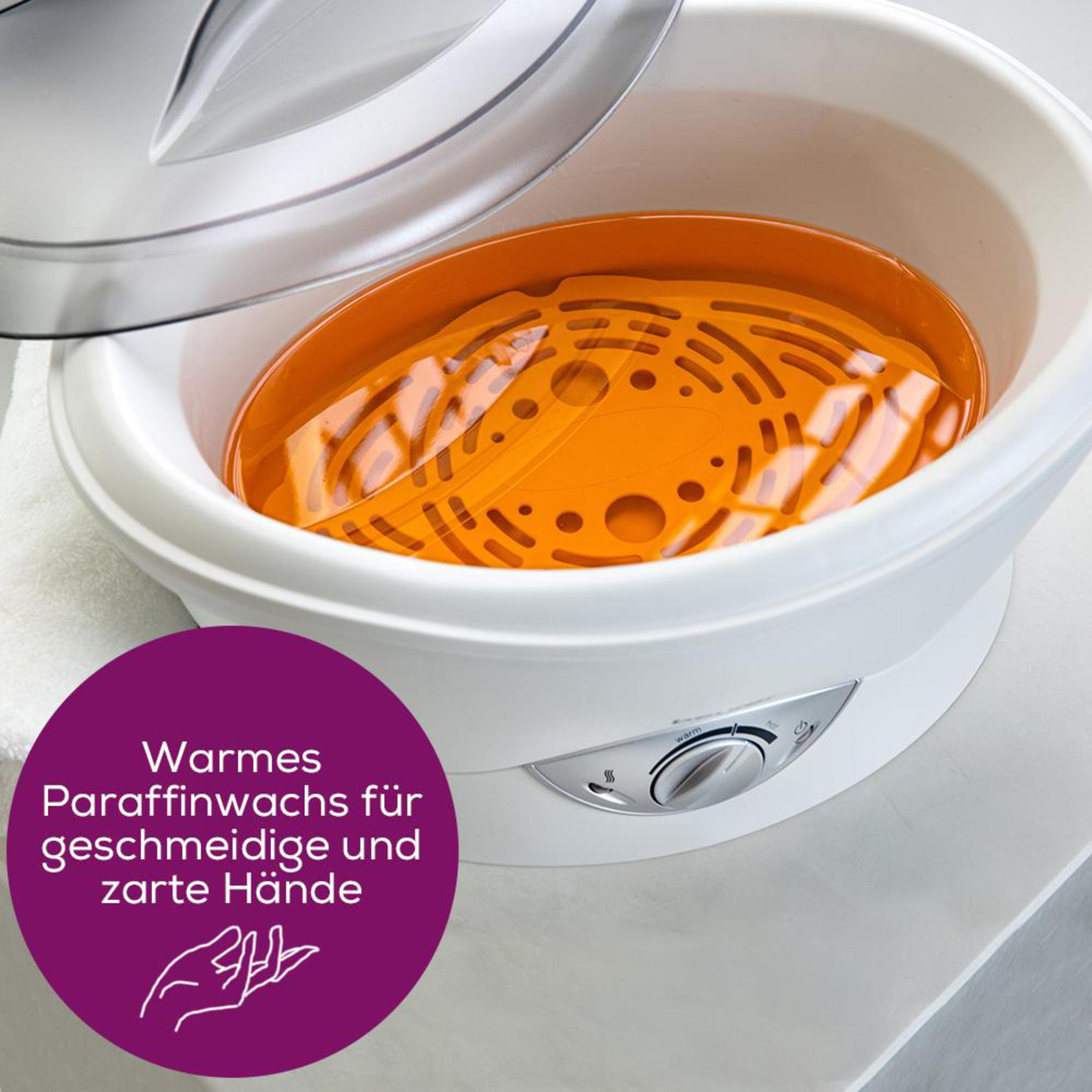 Ein weißer Paraffinwachs-Erwärmer mit orangem Einsatz und durchsichtigem Deckel.