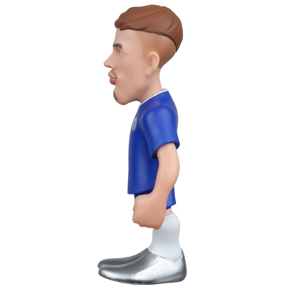 Figurka piłkarza w niebieskiej koszulce i srebrnych butach, widziana z profilu.