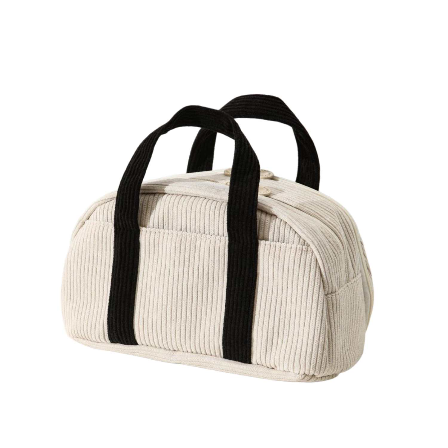 Eine cremefarbene Kordtasche mit schwarzen Griffen, auf weißem Hintergrund.
