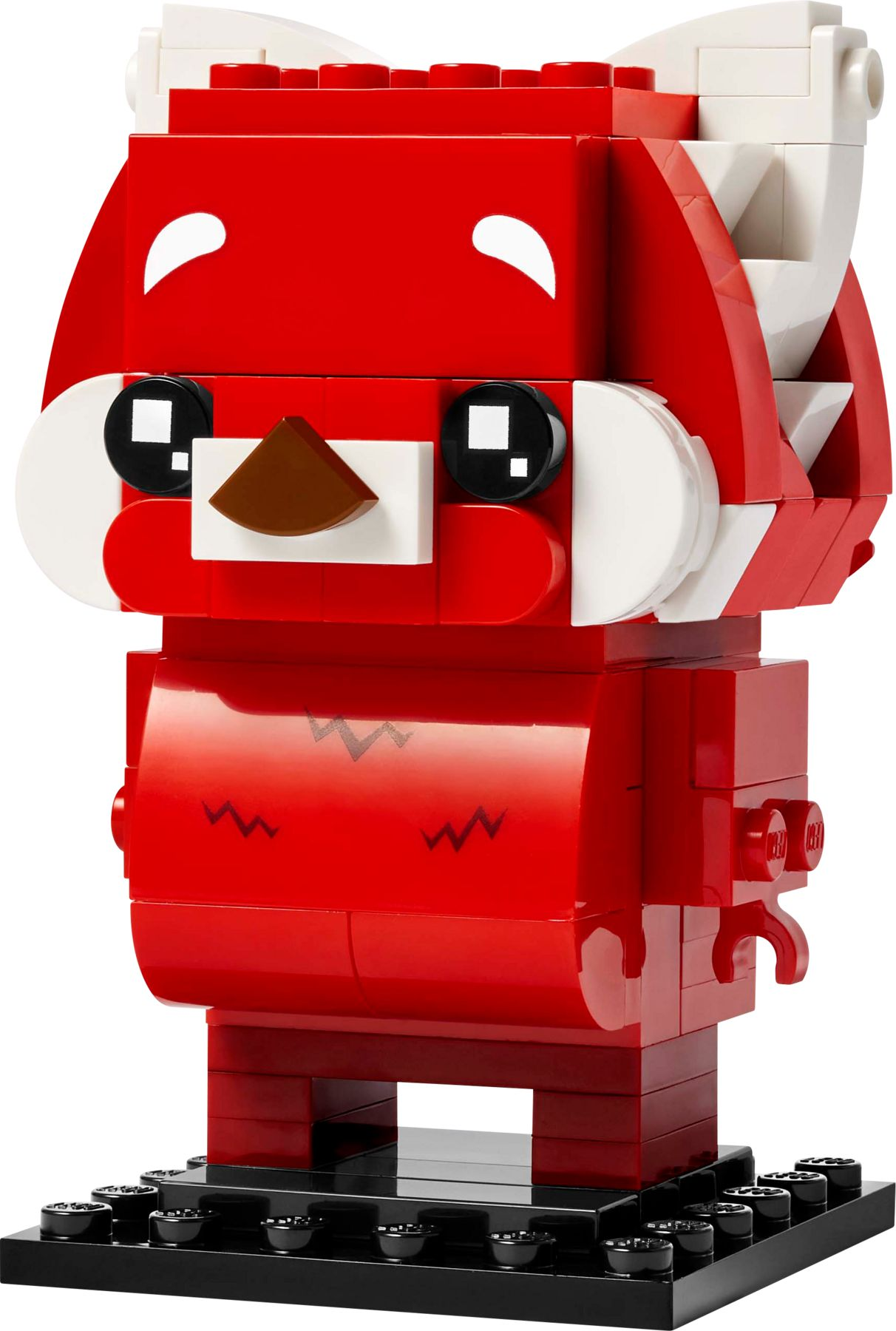Ein rotes Lego-Tier mit weißen Akzenten und schwarzen Augen auf einem schwarzen Sockel.