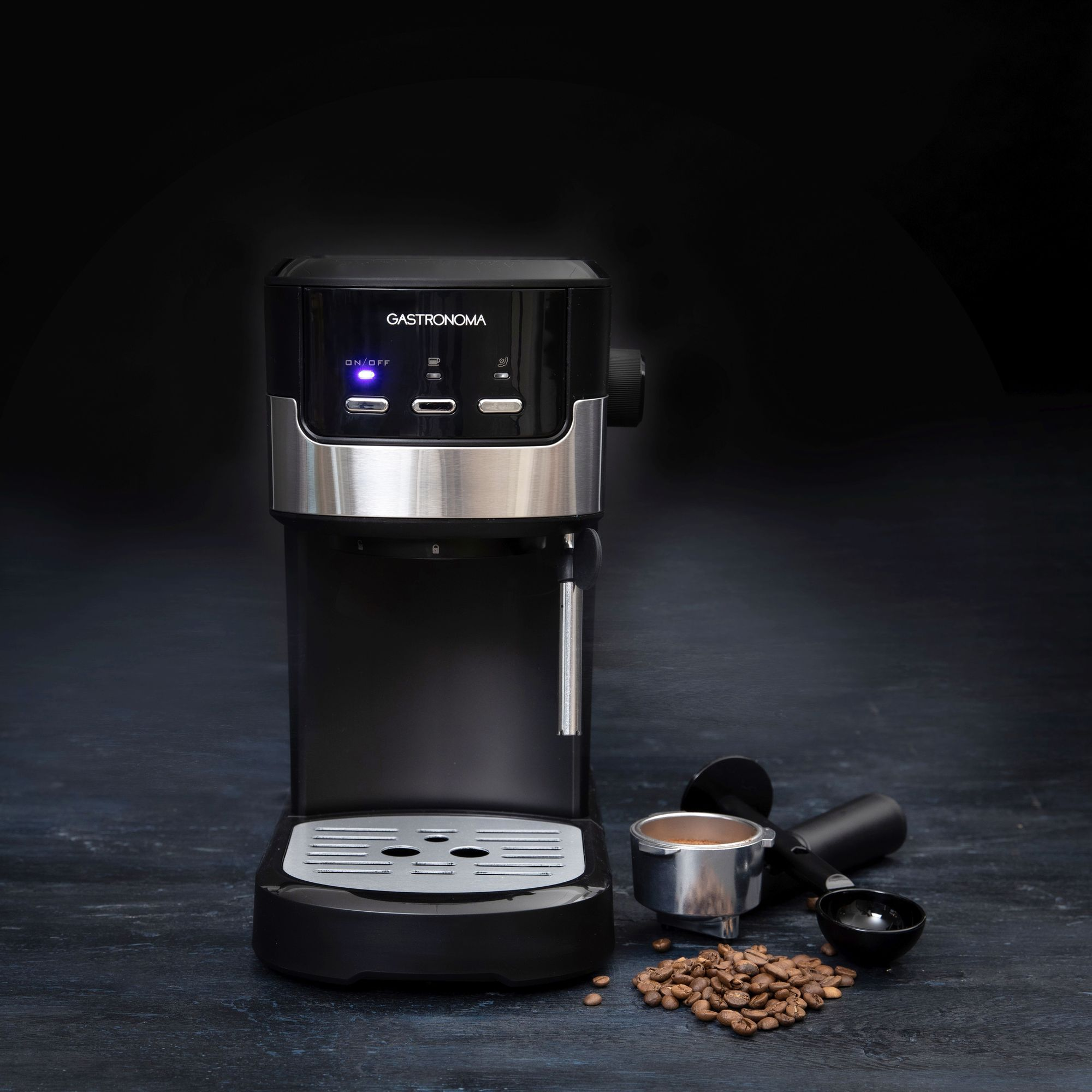 Czarna ekspres do kawy Gastronoma z ziarnami kawy i akcesoriami.