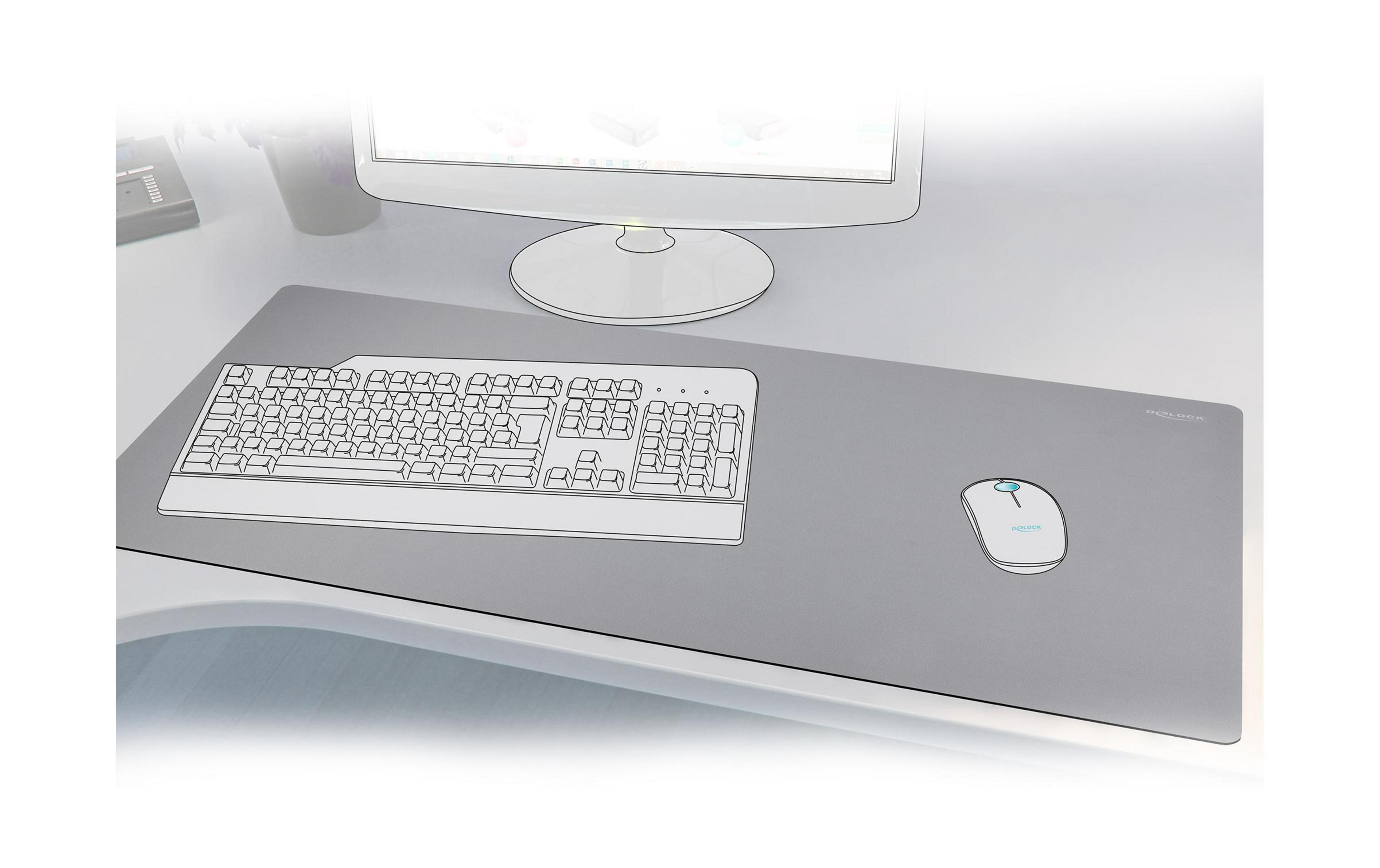 Grauer Schreibtisch mit Tastatur, Maus und Monitor.