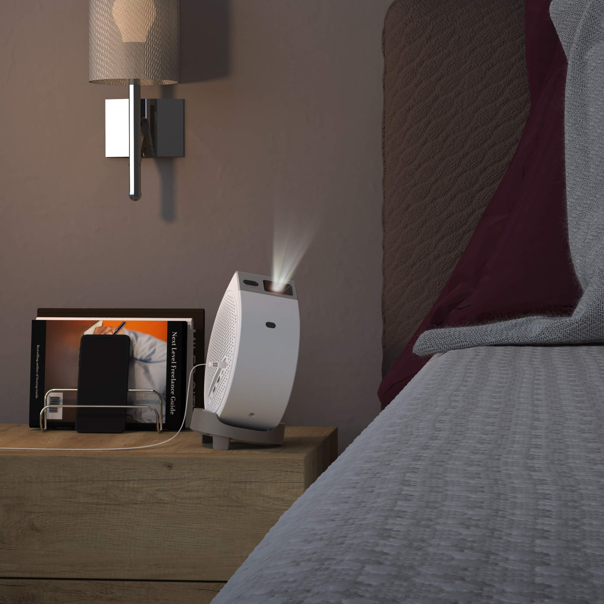 Un proyector blanco proyecta luz sobre una cama junto a una mesita de noche con libros y un teléfono.