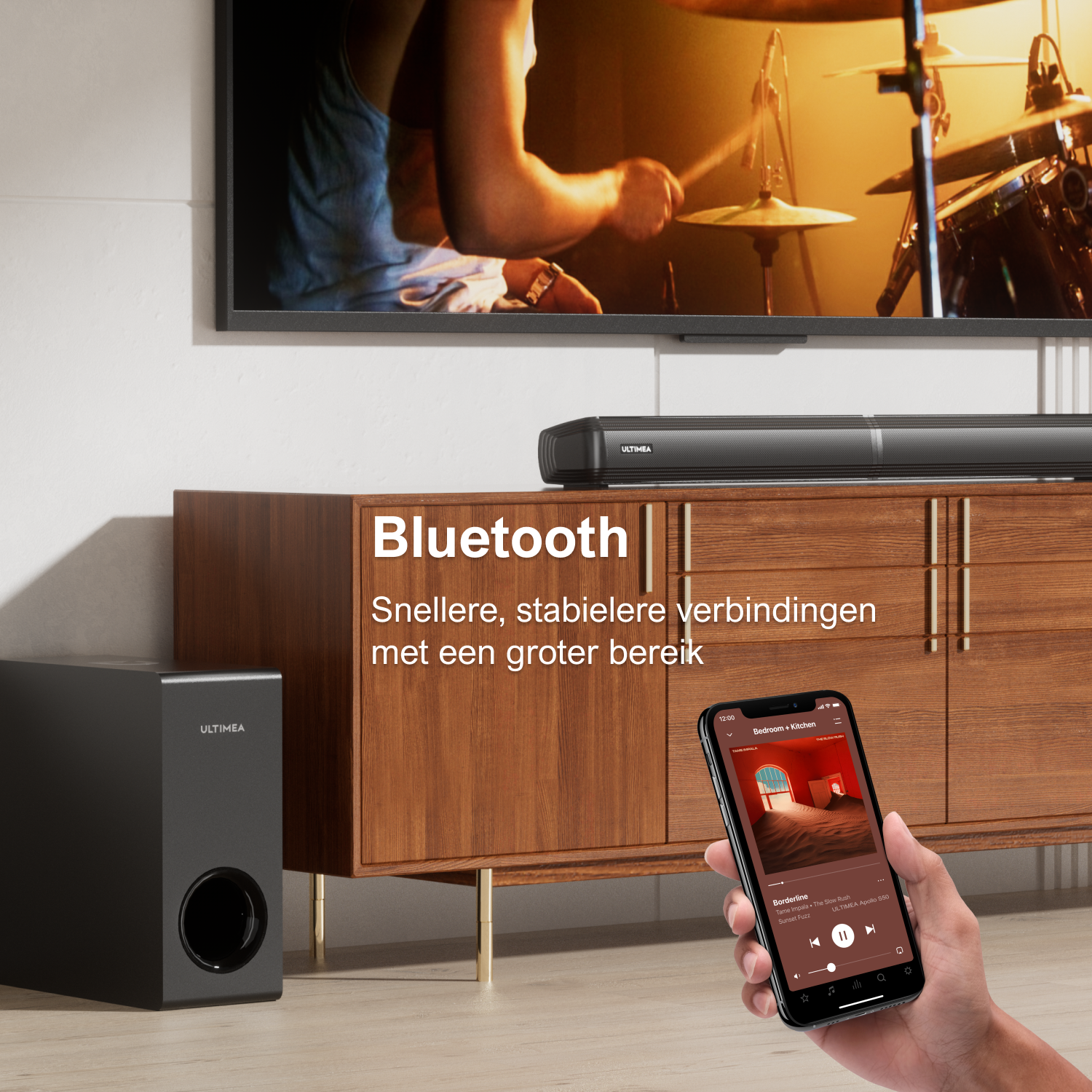 A black subwoofer and soundbar sit before a wooden cabinet. A phone displays music.