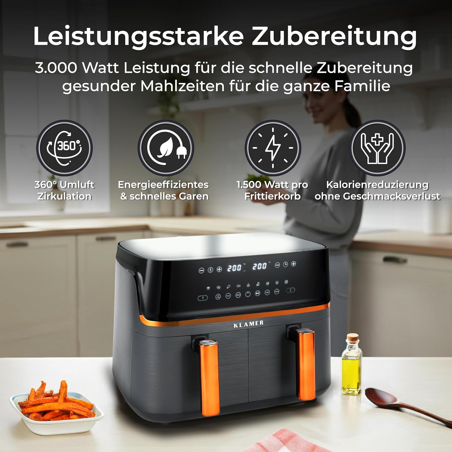 Ein schwarzer und orangefarbener Doppelluftfritteusen-Küchengerät auf einem Tisch, mit Pommes Frites.