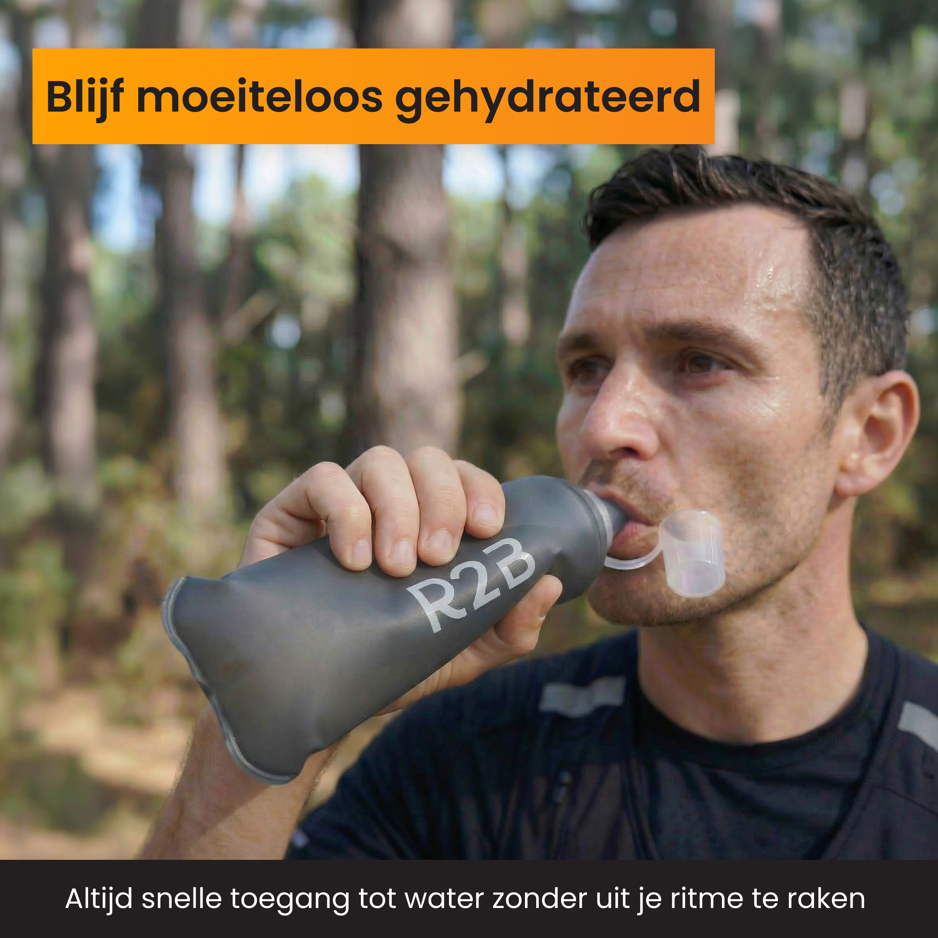 A man drinks from a gray R2B bottle outdoors.