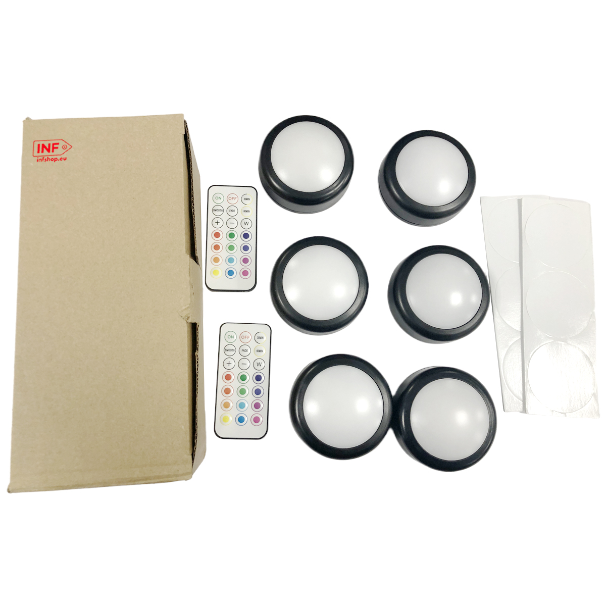 Zes ronde LED lampen met afstandsbedieningen en plakpads op karton.