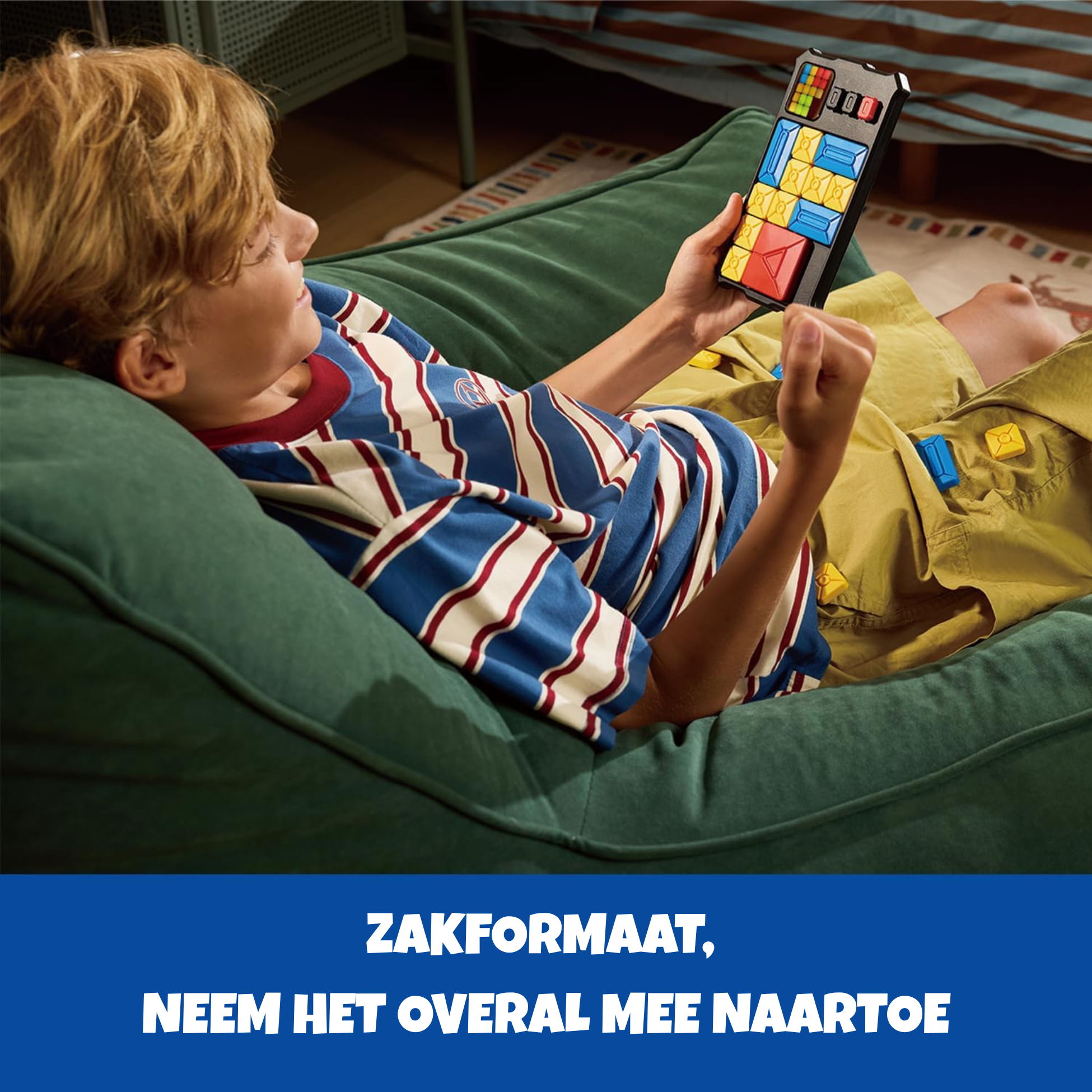 Boy playing a logic game on a green beanbag.