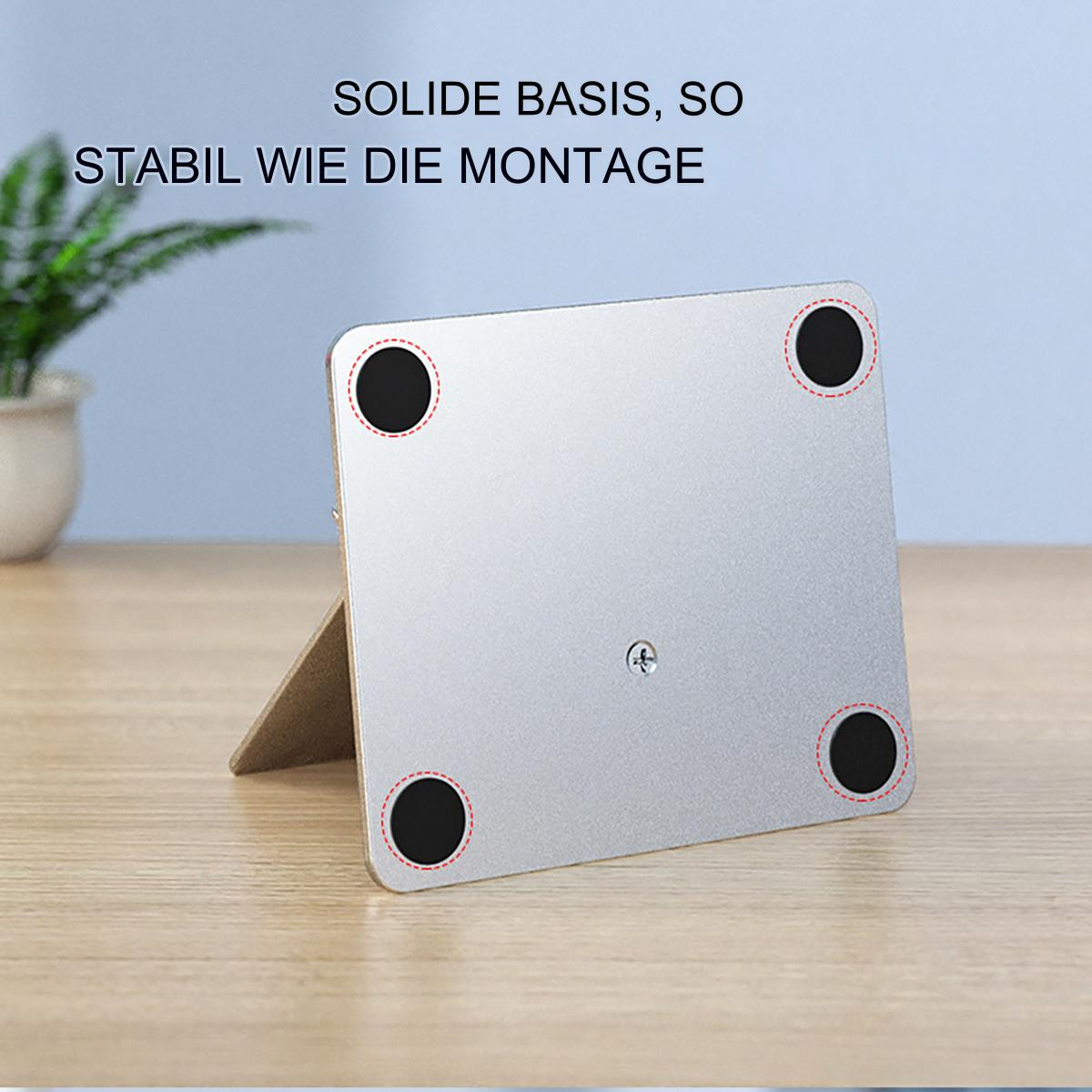 Silberne Halterung mit vier schwarzen Gummifüßen und einer Schraube.