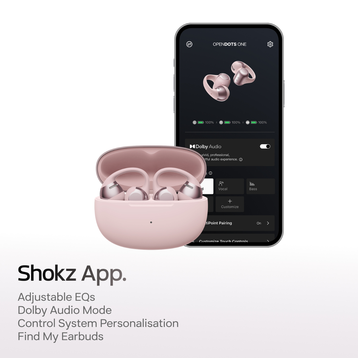 Różowe słuchawki w etui ładującym obok smartfona wyświetlającego aplikację Shokz.