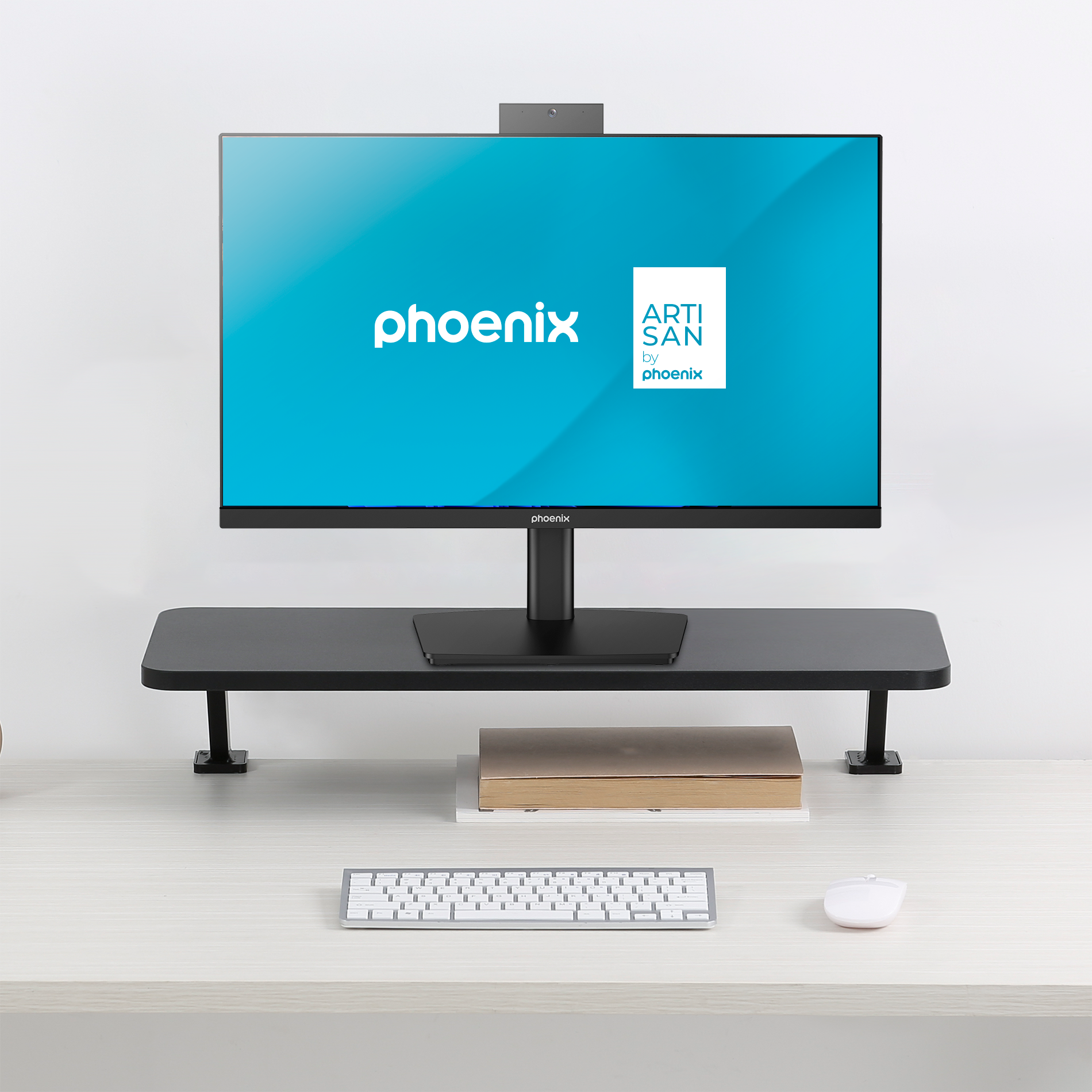 Un escritorio moderno con monitor, teclado, ratón y libro.