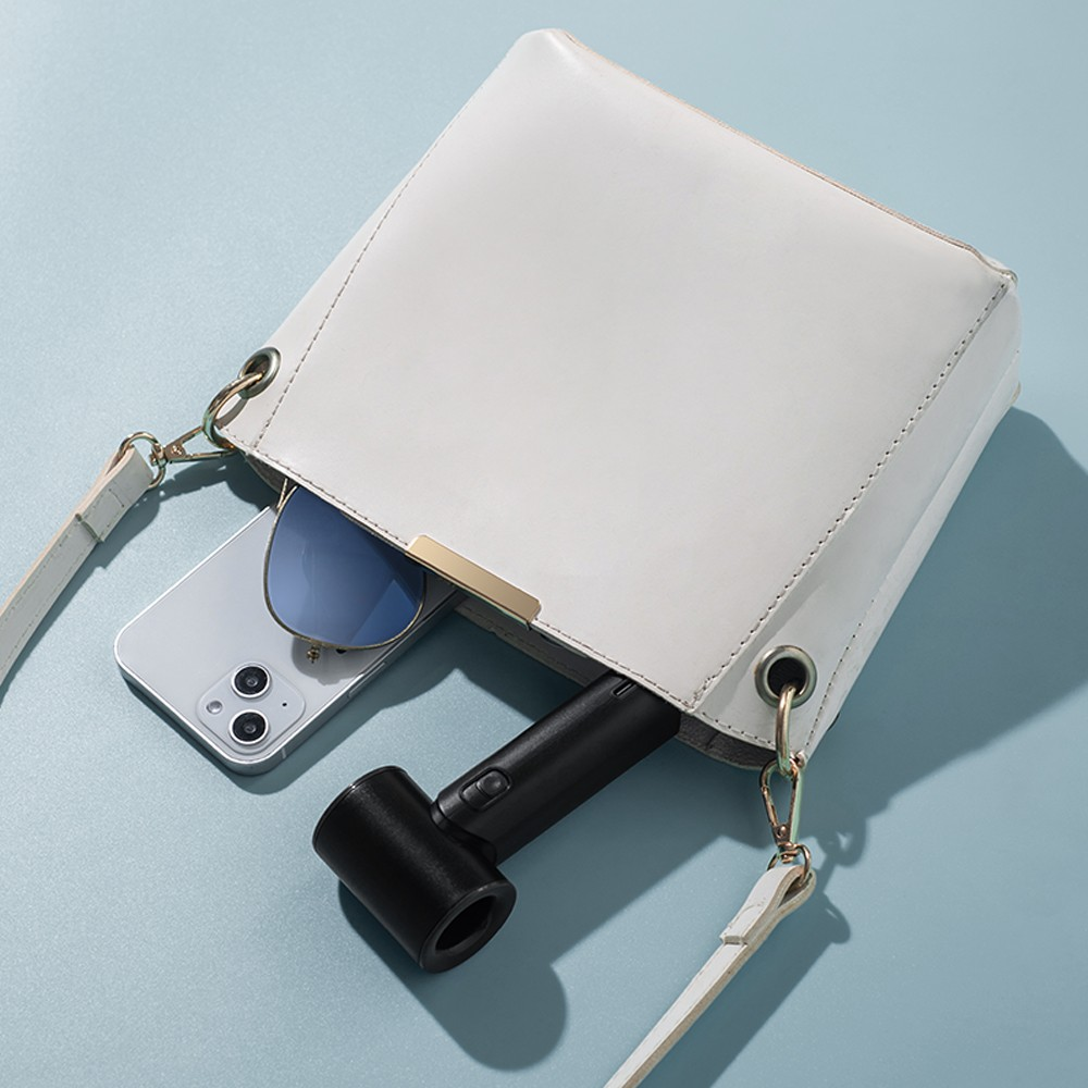 Un bolso blanco con teléfono, gafas de sol y secador de pelo sobre fondo azul.