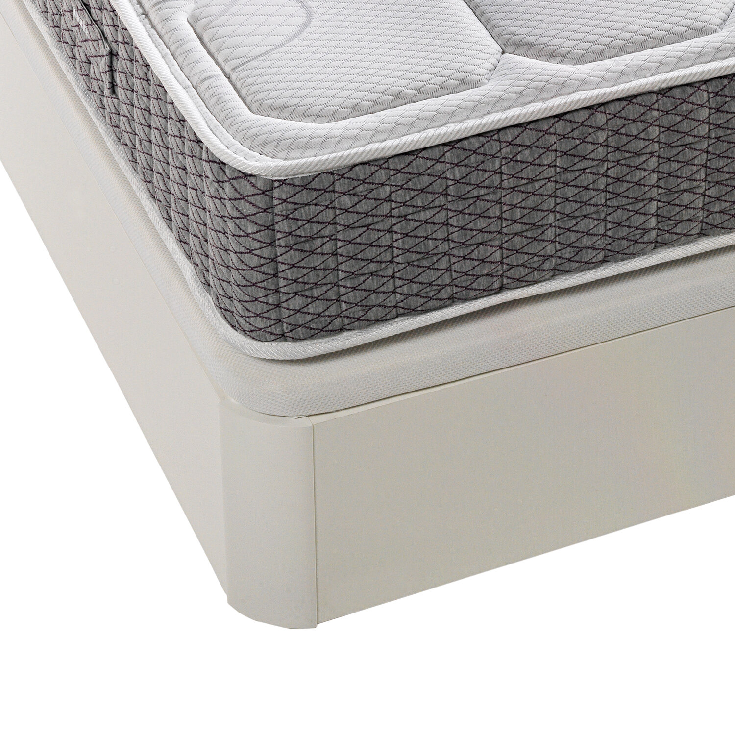 Primer plano de un colchón sobre una base de cama beige claro con borde blanco.