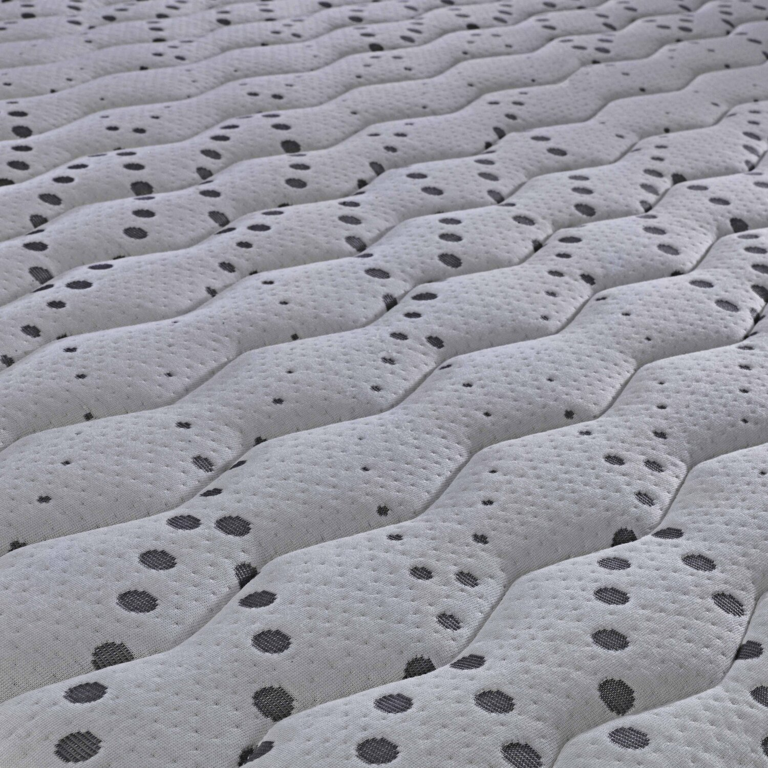 Textura acolchada con patrón ondulado y puntos oscuros.