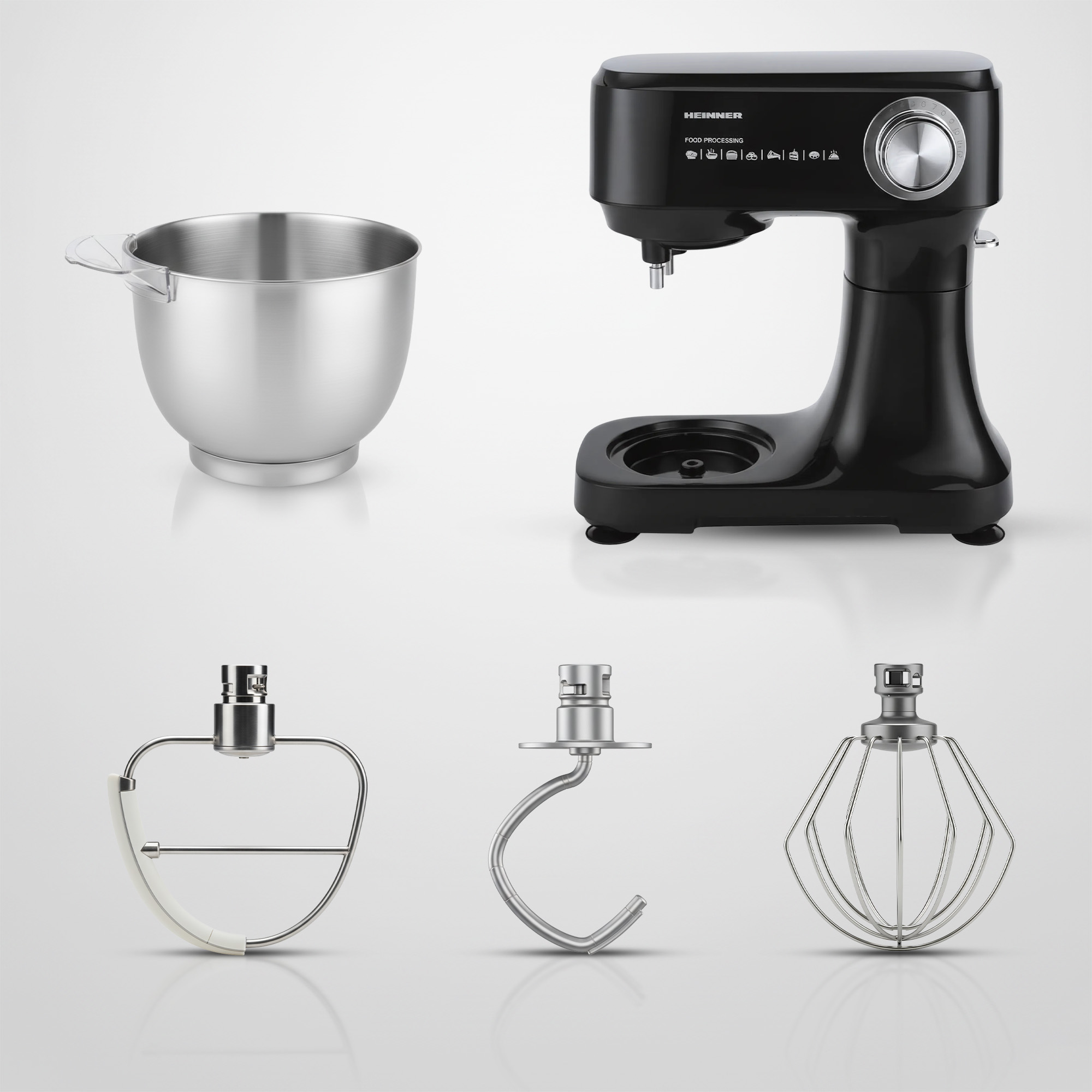 A black stand mixer with a silver bowl and three attachments.