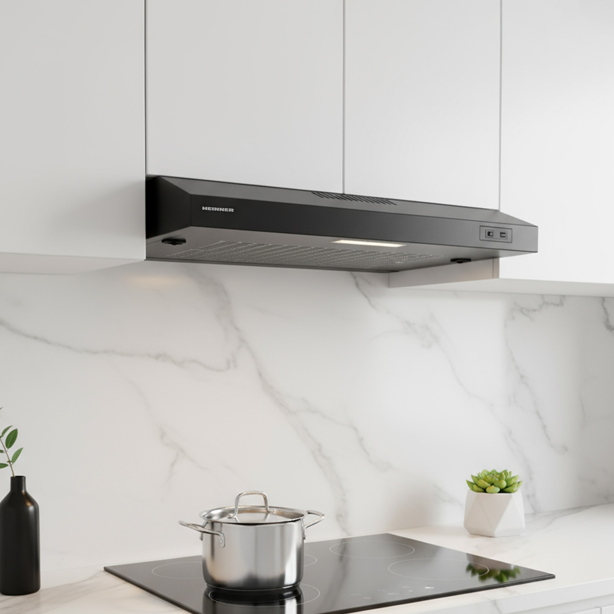 A black range hood, pot, and plant on a marble surface.