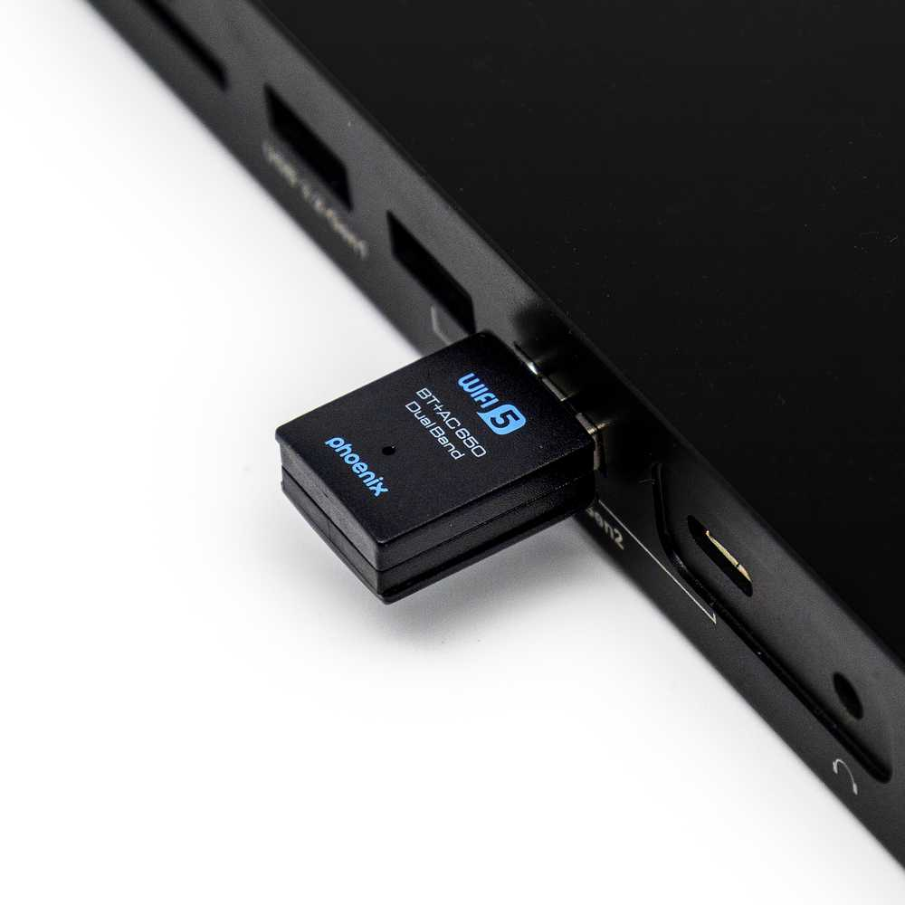 Un adattatore WiFi nero con etichetta "Phoenix" e "WiFi 5" è inserito in un dispositivo nero.