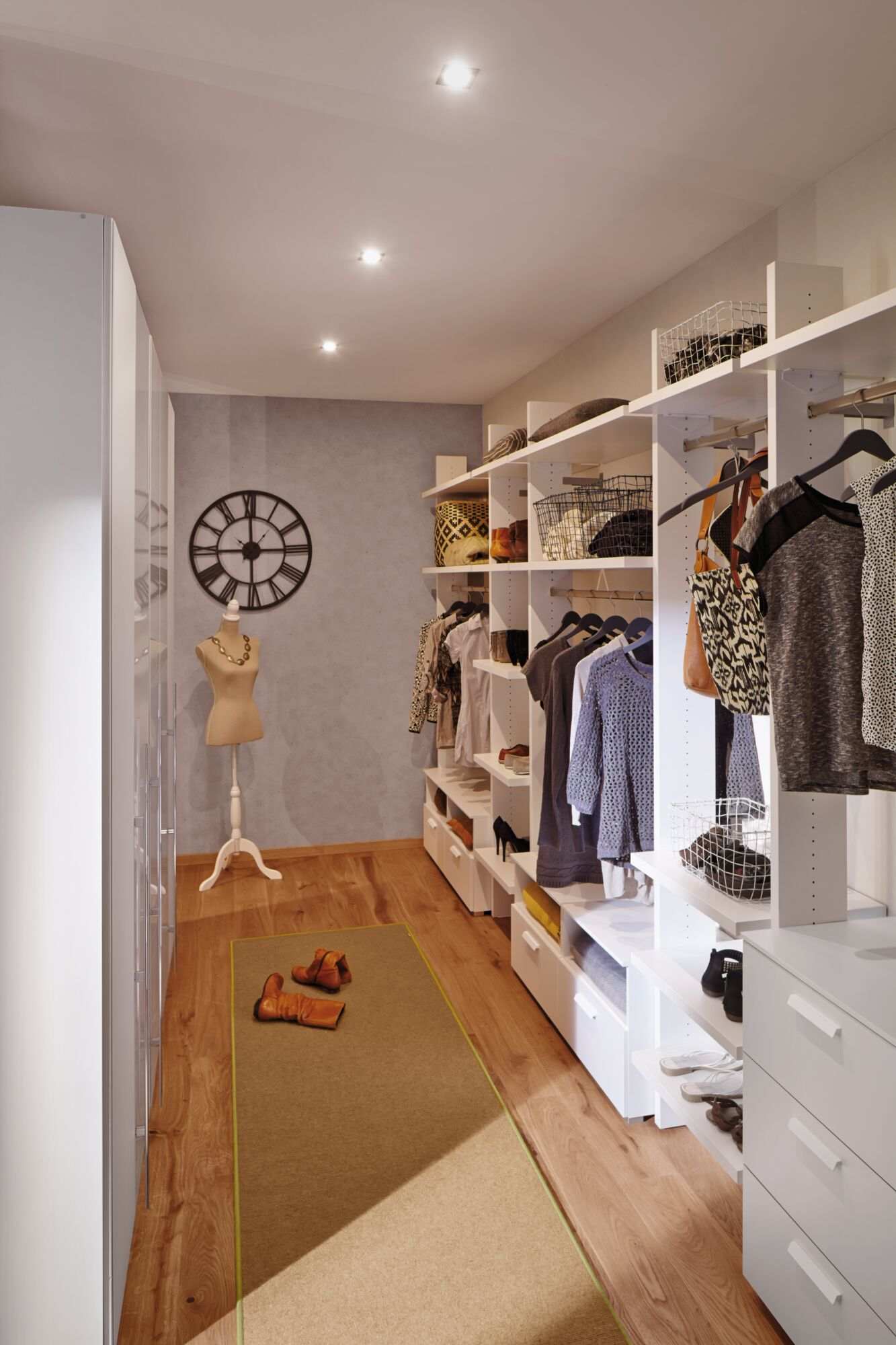 Ein begehbarer Kleiderschrank mit Kleidung, Schuhen, Körben und einer Mannequin.